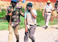 A policeman escorts injured Noida District Magistrate Deepak Agarwal. 