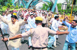 Policemen try to stop Rashtriya Lok Dal (RLD) supporters on their way to Bhatta village to meet the farmers during a protest demonstration against land acquisition in Noida on Sunday