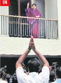 AIADMK leader Jayalalithaa gestures to her party supporters from the balcony of her Poes Garden house in Chennai 