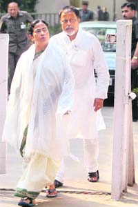 TMC supremo Mamata Banerjee with party leader Mukul Roy after meeting with Congress chairperson Sonia Gandhi in New Delhi on Monday