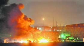 SUNDAY STRIKE: Flames belch from the military base