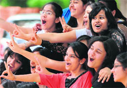 Its a girl thing: Girls flash the victory sign after checking their Class XII examinations results, which were declared in seven regions across the country.