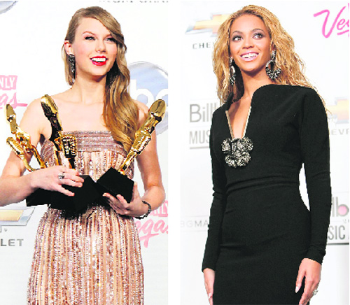 Singer Beyonce and Tylor Swift pose in the photo room after winning Billboard's Millenium award during the 2011 Billboard Music Awards show in Las Vegas on May 22. Swift won three awards — top country artiste, top Billboard 200 artiste and top country album for "Speak Now" .