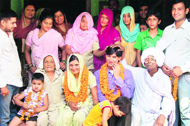 Vikas Kaushik and wife Sushma with their elated relatives at Jalalpur village 