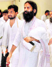 The yoga guru arrives to talk to mediapersons in Haridwar on Sunday