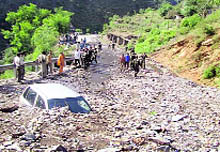 A car lies buried in debris after Wednesdays cloudburst