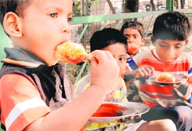 Beating the heat: Children enjoy ice candies at a park in Pahse-I, Mohali, on Tuesday