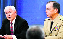 US Secretary of Defence Robert Gates (L) speaks during his final official news conference at the Pentagon, near Washington. Alongside Gates is chairman of the Joint Chiefs of Staff, Admiral Mike Mullen