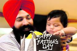 The father-son duo of Hardeep Singh and Manavdeep Singh celebrate Father’s Day by cutting a cake in Ludhiana on Sunday