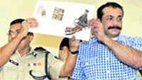 Mumbai Joint CP Crime Himanshu Roy shows the weapon used to kill Dey