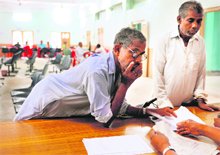 Farmers unwilling to give their land to Tata Motors talk to officials at the office of the district collectorate in Singur, 45 km north of Kolkata, on Wednesday. 