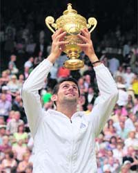 Novak Djokovic of Serbia with the trophy after defeating Rafael Nadal of Spain in the men's singles final at the Wimbledon tennis championships in London on Sunday
