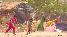 Children run for shelter after a dust storm hit Ludhiana on Sunday evening.