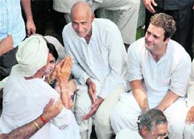 A farmer greets Congress general secretary Rahul Gandhi during his visit to Nangla Bhatana village in Greater Noida on Tuesday