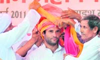 Rural touch: Farmers honour Congress general secretary Rahul Gandhi with a turban at the Kisan Mahapanchayat in Aligarh 
