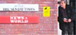 A security guard at the entrance to News International offices in Wapping, London. 