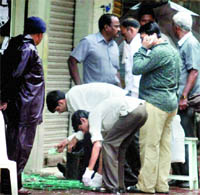 Forencic experts collect evidence from the blast site at Dadar in Mumbai on Thursday.