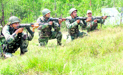 Army jawans take up positions near the encounter site at Maidanpora village in Kupwara