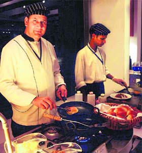 FIRED UP: Chefs busy creating delicacies at the street food festival at Taj