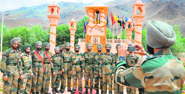 A jawan clicks a picture of his friends on the occasion of the 12th anniversary of the Kargil War in Drass 
