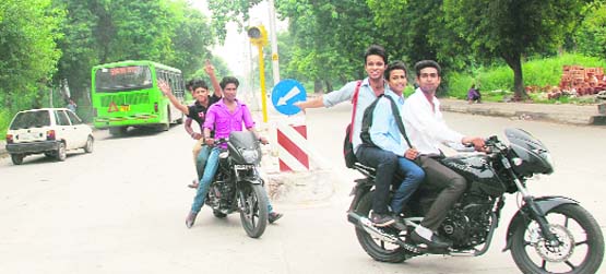 Youngsters driving recklessly on the wrong side of the road and without helmets in Chandigarh