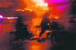 Rain catches a rickshaw-puller unawares in Chandigarh