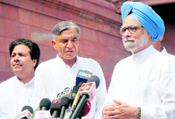 PM Manmohan Singh with Union ministers Pawan K Bansal and Rajiv Shukla.