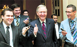 Senate Minority Leader Mitch McConnell is all smiles as he walks to the Senate floor to announce that a deal has been reached on the debt ceiling in Capitol Hill in Washington on Sunday.