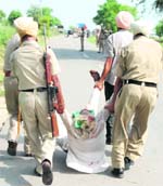 Punjab police personnel take away a protesting farmer