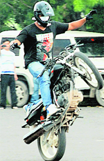 Perilous Feat A youth uses a stretch of road to hone his biking skills in Sector 5, Panchkula, on Wednesday