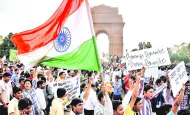 PROTESTS SWELL: Anna Hazares supporters hold a protest at India Gate in New Delhi on Wednesday