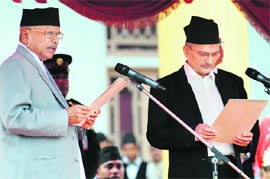 Nepals newly elected Prime Minister Baburam Bhattarai (R) being sworn in by Nepalese President Ram Baran Yadav at the office of the Presidential House in Kathmandu