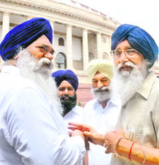 Chief Minister of Punjab Parkash Singh Badal with senior party leaders outside Parliament in New Delhi on Friday.