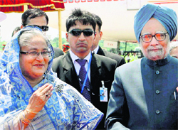 Prime Minister Manmohan Singh with his Bangladeshi counterpart Sheikh Hasina during his welcome at Hazrat Shahjalal International Airport in Dhaka on Tuesday