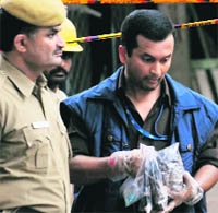 NIA officers collect evidence from the blast site at the Delhi High Court on Thursday 