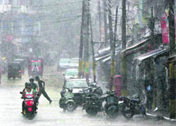 People caught unawares in a downpour in Jammu on Thursday.