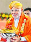 Narendra Modi receives a bowl of fruits from his supporters on the first day of his fast in Ahmedabad. 
