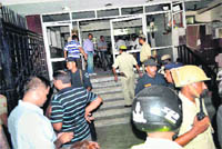 Security officers examine the blast site in Agra. 