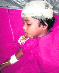 A child who was injured in a building collapse after the earthquake being treated at a hospital in Siliguri