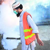 A man fumigates in Lahore on Sunday