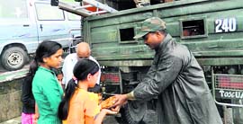 Army personnel distribute food among the quake-hit locals in Gangtok.