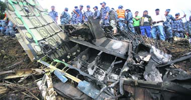 Nepalese police personnel are seen at the crash site of Buddha Air plane in Lalitpur near Kathmandu