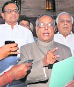 Union Finance Minister Pranab Mukherjee with Home Minister P Chidambaram talking to the media after meeting the PM in New Delhi on Thursday. 