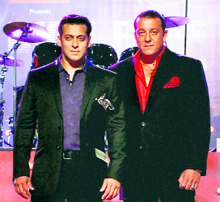 Bollywood stars Sanjay Dutt and Salman Khan perform during an event to announce the names of the 14 inmates of Bigg Boss 5 in Mumbai