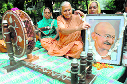 A woman tries her hand at a charkha to mark Gandhi Jyanti in Chandigarh on Sunday