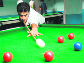A youngster takes his best shot at a billiards lounge