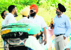 Members of the Masters Cadre Union, who were protesting, guzzle beer at Phase VIII in Mohali on Sunday