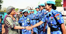 Liberian President Ellen Johnson Sirleaf (L) shakes hands with the Indian women CRPF contingent which takes care of her security in Monrovia, the capital of Liberia.