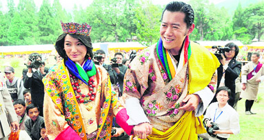 Newly crowned Queen of Bhutan Jetsun Pema and King of Bhutan Jigme Khesar Namgyel Wangchuck acknowledge the crowds after their wedding at the Dzong monastery on Thursday. Bhutans 31-year-old king married Pema, who is 10 years his junior, in a colourful ceremony showcasing the rich Buddhist culture.