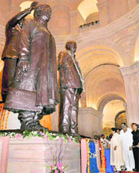 Mayawati lights candles at the feet of her own statue (extreme left) and that of Kanshi Ram to inaugurate the Ambedkar Park in Noida. 
